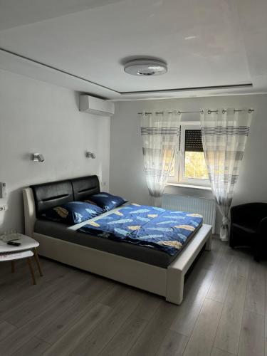 a bedroom with a bed and a window at Willa Euforia in Poznań