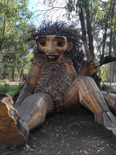 a statue of a person sitting in a tree at Falcon Estuary Escape in Wannanup
