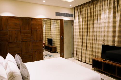a bedroom with a bed and a flat screen tv at Enrise by Sayaji Nagpur in Nagpur