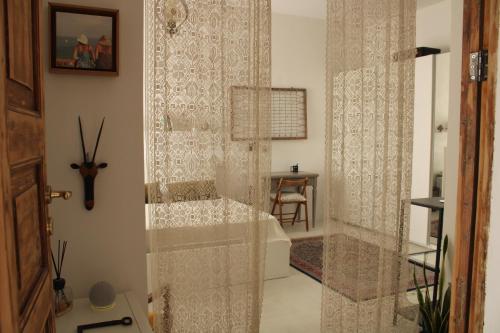 a bathroom with a shower with a shower curtain at Casa Vittoria Martina Franca in Martina Franca