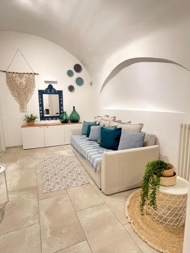 a living room with a couch and a mirror at L Antico Forno Bari Centro Storico in Bari