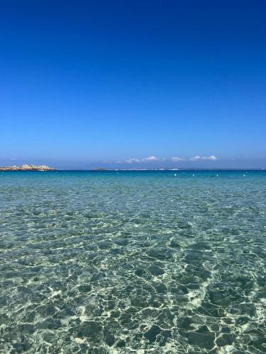 a large body of water with rocks in it at Hotel Corallaro in Santa Teresa Gallura