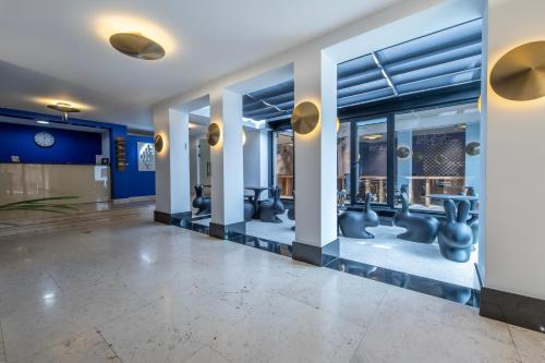 a lobby with blue walls and white columns at Urban Boutique Hotel in Tbilisi City