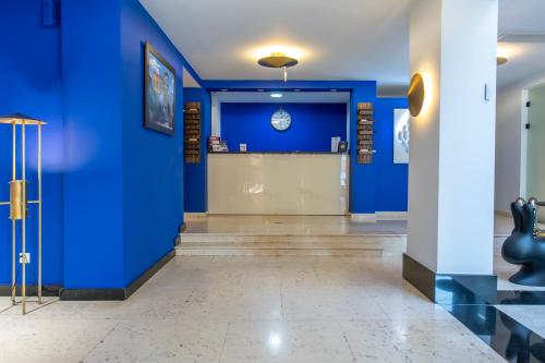 a hallway with a blue wall and a waiting room at Urban Boutique Hotel in Tbilisi City