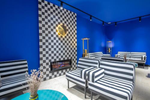 a room with three chairs and a fireplace at Urban Boutique Hotel in Tbilisi City