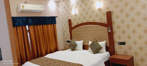 a hotel room with two beds and a window at Varanasi Villa(B&B) in Varanasi