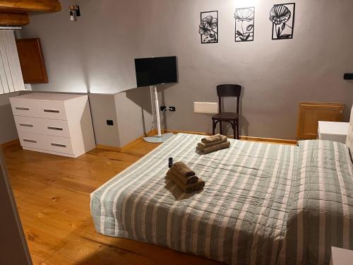 a bedroom with a bed with two towels on it at Sardinia Costa Ovest in Càbras