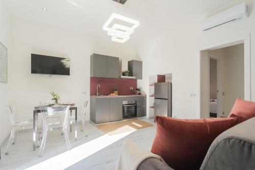 a kitchen and living room with a couch and a table at Cernobbio Dream Suites by Rent All Como in Cernobbio