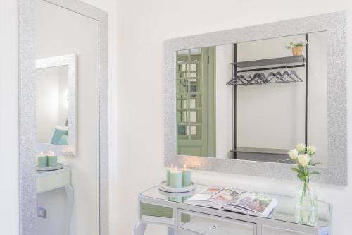 a bathroom with a mirror and a table with a sink at Cernobbio Dream Suites by Rent All Como in Cernobbio
