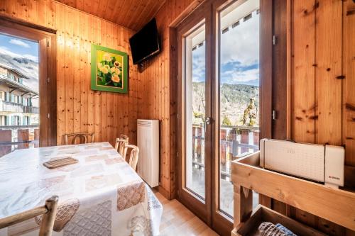 a room with a table and a large window at Au soleil des coeurs - 6 pers in Morzine