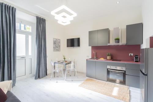 a kitchen with a table and a kitchen with a fireplace at Cernobbio Dream Suites by Rent All Como in Cernobbio