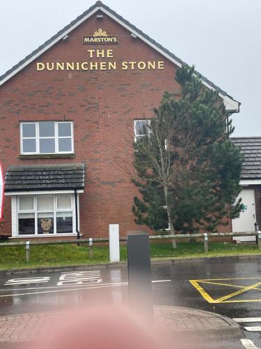 a building with a sign that reads the duntherhen store at 6 Rannoch, lovely holiday static caravan for dogs & their owners. in Forfar