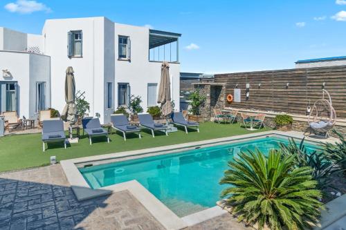 - une piscine dans l'arrière-cour d'une maison dans l'établissement Anemomiloi Andros Boutique Hotel, à Andros