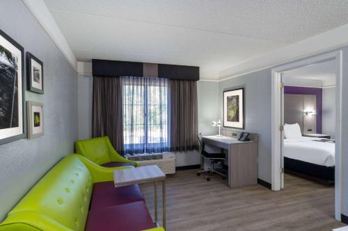 a hotel room with a bed and a desk at La Quinta by Wyndham Birmingham Hoover in Hoover