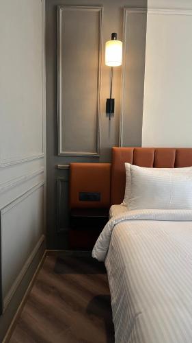 a bedroom with a bed and a mirror on the wall at Ramada Encore by Wyndham Indore Nipania in Indore
