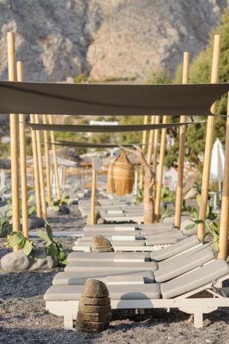 a row of books lined up on the ground at Afroditi Venus Beach Resort in Kamari