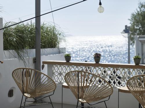 a table and chairs on a balcony with the ocean at Afroditi Venus Beach Resort in Kamari