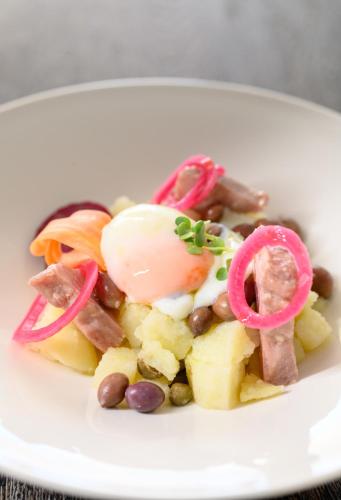 a white plate of food on a table at Afroditi Venus Beach Resort in Kamari