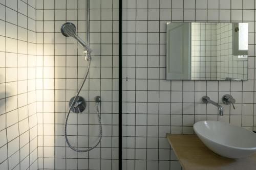 a bathroom with a shower and a sink at Afroditi Venus Beach Resort in Kamari