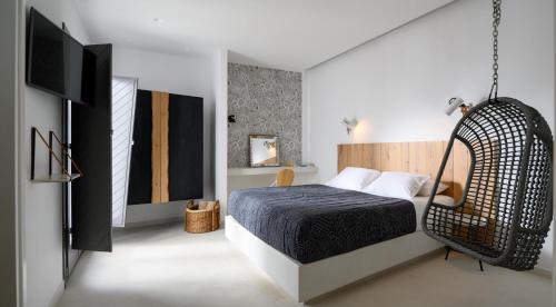 a bedroom with a bed with a swing at Afroditi Venus Beach Resort in Kamari