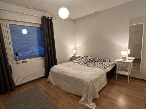 a bedroom with a bed and a window at ”Paris” -2BR with sauna&balcony in Tornio