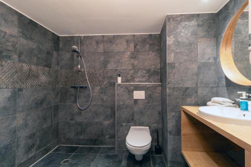 a bathroom with a shower and a toilet and a sink at Le Parc 42 Saint-Etienne in Saint-Étienne