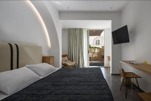 a hotel room with a bed and a desk at Afroditi Venus Beach Resort in Kamari