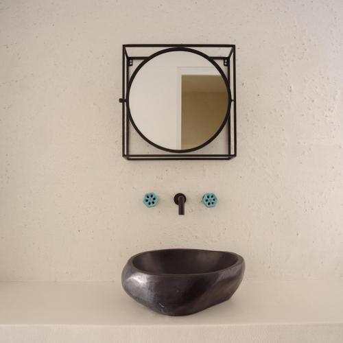 a bathroom sink with a mirror on the wall at Afroditi Venus Beach Resort in Kamari