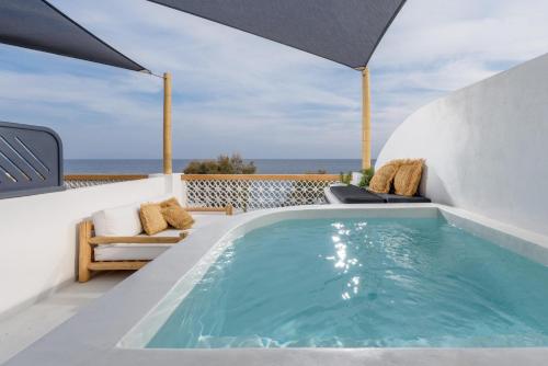a swimming pool on the roof of a house at Afroditi Venus Beach Resort in Kamari
