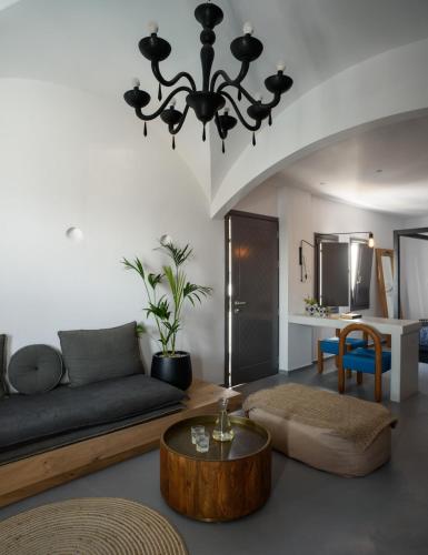 a living room with a couch and a table at Afroditi Venus Beach Resort in Kamari