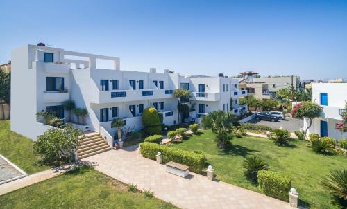 an aerial view of a white apartment building at Hotel Hara Ilios Village in Gouves