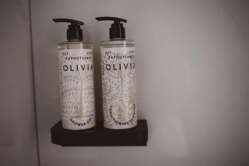 two bottles sitting on a shelf in a room at Hotel Hara Ilios Village in Gouves