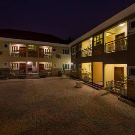 an empty courtyard of a building at night at Sidney Apartment in Ilorin