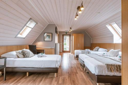 two beds in a room with skylights at Charming Roger's Farm in Kortrijk