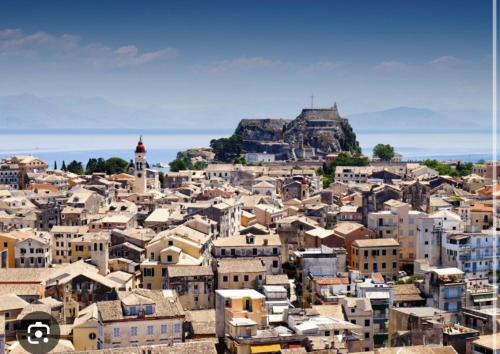 a city with buildings and a mountain in the background at Angel's Loft! in Agios Rokkos