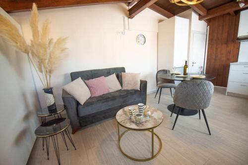 a living room with a couch and a table at Angel's Loft! in Agios Rokkos