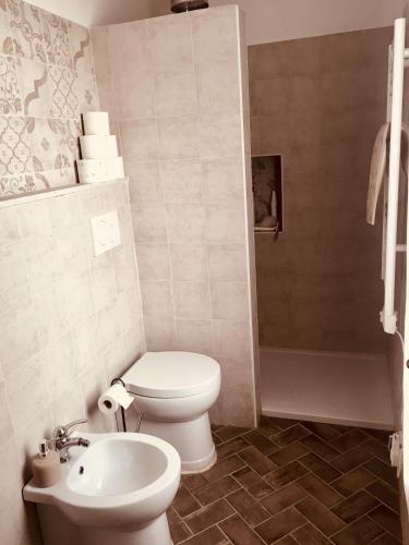 a bathroom with a toilet and a sink at Poderino di Santa Lucia in Villa Nagliati