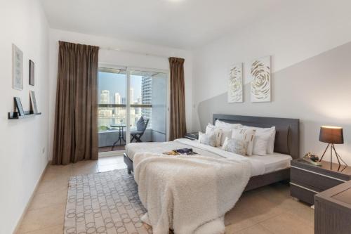 a hotel room with two beds and a balcony at The Smart Concierge - Elite Residence in Dubai