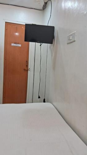 a room with a bed and a light and a door at CHENNAI PLAZA in Chennai