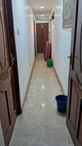 a long hallway with a door and ailed floor at CHENNAI PLAZA in Chennai