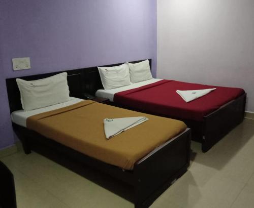 two beds sitting next to each other in a room at CHENNAI PLAZA in Chennai