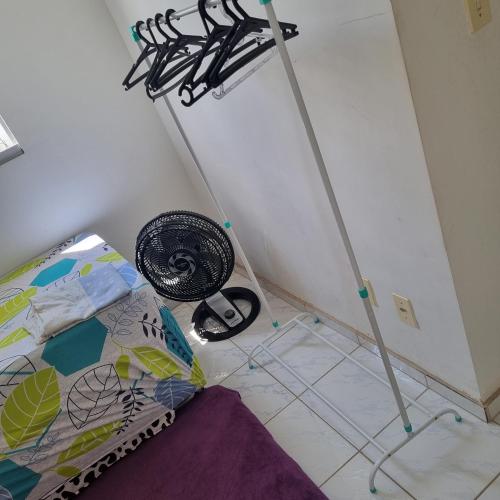 a bedroom with a bed and two antenas at Quarto in Maceió