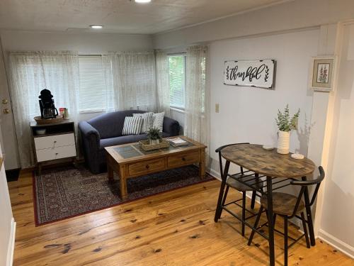 a living room with a couch and a table at The Iris Garden Downtown Cottages and Suites in Nashville