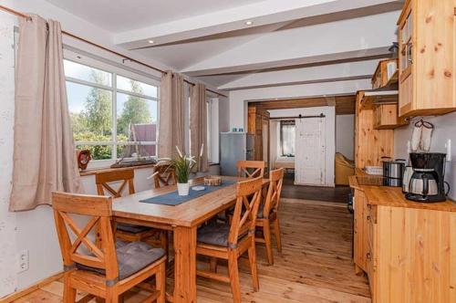 a dining room with a wooden table and chairs at Dünenblick 3 in Ueckeritz