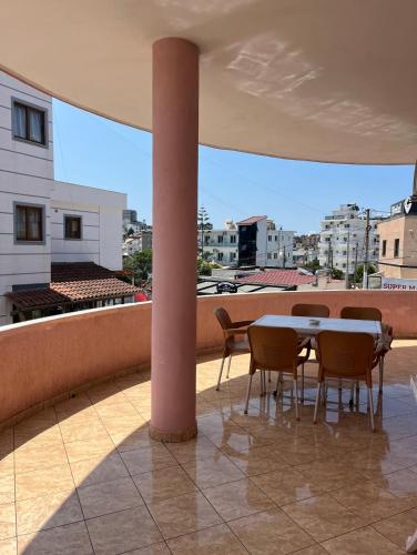 a patio with a table and chairs on a balcony at Vila Spiro in Ksamil