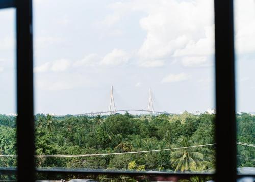 a view of a bridge from a window at NAM CẦN THƠ HOTEL in Ấp Phú Thạnh (4)