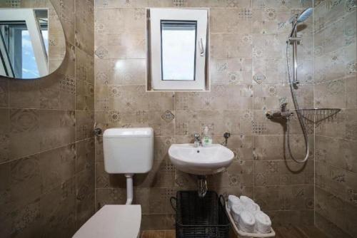 a bathroom with a sink and a toilet and a shower at Villa Ivana Whisper of nature in Vodice