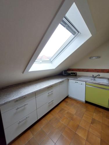 a kitchen with a large skylight in the ceiling at Ferienwohnung Jäger in Viereth-Trunstadt