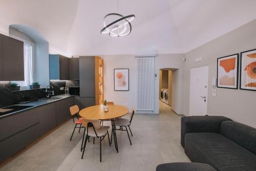 a kitchen and living room with a table and a couch at Sea Glow Luxury Apartment 2BR 2BA con vista mare a Bisceglie in Bisceglie