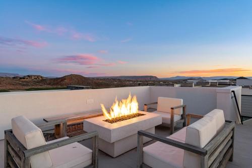 a patio with a fire pit and chairs on a roof at Bunker on the 8th in Washington